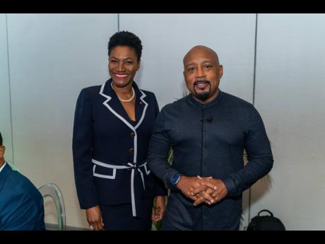 Audrey Tugwell Henry (left), president and chief executive officer of Scotia Group Jamaica, and Daymond John.