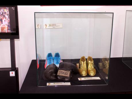 Credit: Paul Williams In this space are Asafa Powell’s autographed spikes, Veronica Campbell-Brown’s autographed spikes, and boxer Michael McCallum’s gloves from the 1976 Olympics in Montreal, Canada.