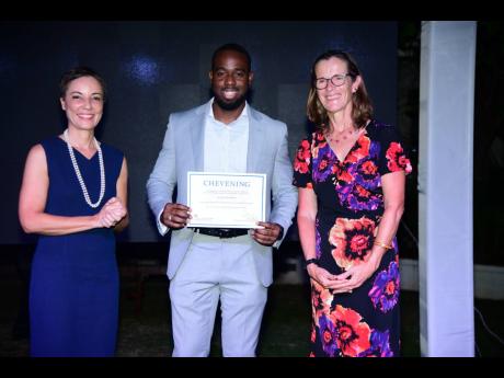 Credit: Antoine Lodge Senator Kamina Johnson Smith, minister of foreign affairs and foreign trade, and Judith Slater, British high commissioner to Jamaica, present Sayeed Bernard with his certificate of acceptance at the 2024 Chevening Scholarship Award Ceremony and Reception.