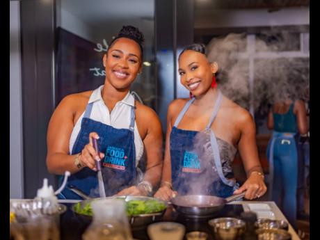 Smiling through the sizzle! Content creators Jada Paige (left) and Alex Murdock brought flavour and fun to the Jamaica Food and Drink Kitchen. 