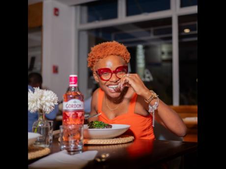 Right: Lecturer and content creator Lamoy Mullings savours the first bite of her culinary creation and beams with pride as a clear stamp of approval. 