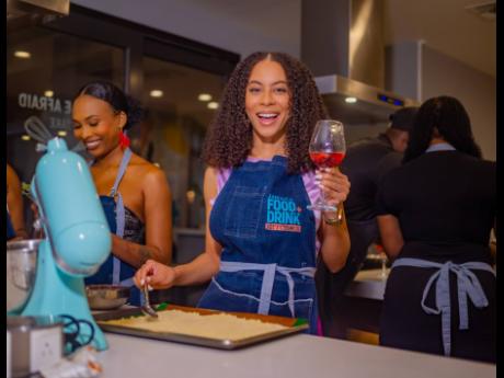 Digital Creator Nyoka Whyne prepares the Scotch bonnet crumble while sipping on her Gordon’s Pink Gin fizz cocktail.