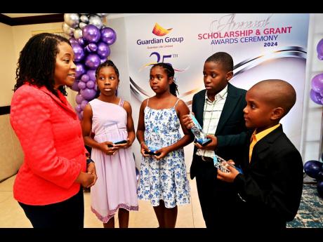 From secont left: President, Guardian Life Limited, Meghan Miller Smith, in conversation with the four top awardees at the Scholarship Awards and Grants Ceremony. From left: Saige Brown, Top Girl GLL Policyholder; Adrianna Cover, National Top Girl, Aiden C
