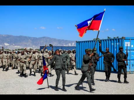 FILE – New members of the Armed Forces of Haiti celebrate after their graduation ceremony in Port-au-Prince, Haiti, Thursday, December 22, 2022.