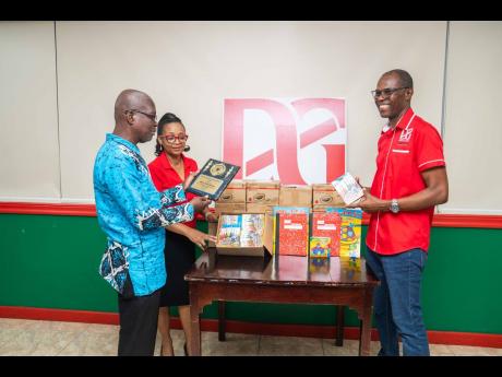 Credit: Contributed Just as D&G Foundation administrator Totlyn Brown Robb and accountant Dennis Beckford (right) were preparing to present to Riverton Meadows Early Childhood, Principal Junior Rowe surprised them by unveiling a plaque he had been eager to share in recognitio