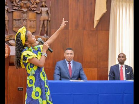 Credit: Contributed Malia Brown performs an item during an awards ceremony held at Jamaica House in St Andrew yesterday for children of employees of the Office of the Prime Minister and the Cabinet Office who were successful in the Primary Exit Profile examinations held earl