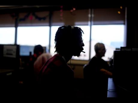 Customer Experience Representative Rico Thomas takes calls at an Alorica centre, Monday, August 19, 2024, in San Antonio.