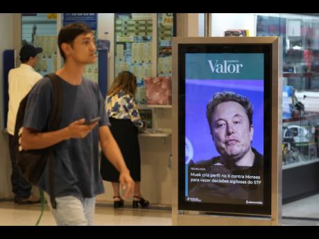 An ad by Valor media shows a photo of Elon Musk at a shopping centre in Brasilia, Brazil, Monday, September 2, 2024. The sign reads in Portuguese: "Musk creates profile on X against Moraes to leak confidential decisions of the Supreme Court," referring to 