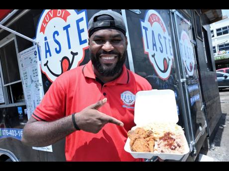 Credit: Rudolph Brown Chef and co-owner of Luv Di Taste, Troy Hanson, showcases the spicy fried chicken.