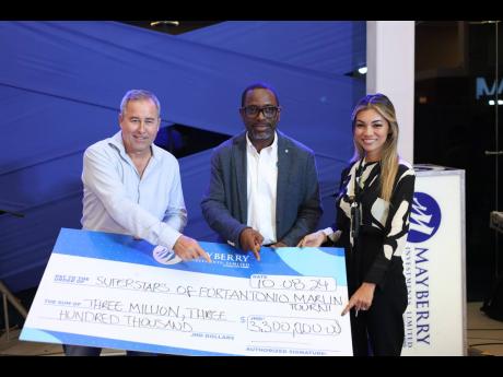 Credit: Contributed Robert ‘Bobby’ Stewart (left) tournament director for the Superstars of Port Antonio International Marlin Tournament collects a sponsorship cheque from Dan Theoc (centre), senior vice-president of investment banking, Mayberry Investment and Stephanie