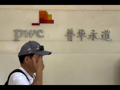 
A man walks by the audit firm PricewaterhouseCoopers office, at the Fortune Financial Center in Beijing on August 27, 2024.