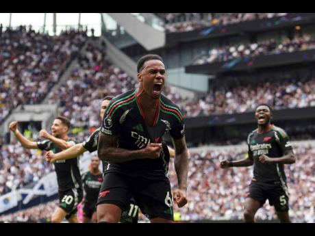 Credit: AP Arsenal’s Gabriel (foreground) celebrates after scoring the winner during the English Premier League match between Tottenham Hotspur and Arsenal in London yesterday.