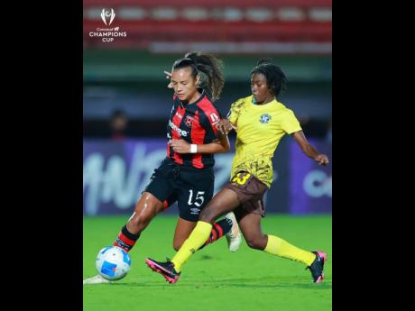 Alajuelense’s Stephannie Blanco tries to go past the outstrestched leg of Frazsiers Whip’s Suen Gregory during their first Concacaf Women’s Champions Cup at the Estadio Alejandro Morera Soto in Costa Rica recently.