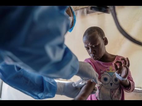 Credit: AP
A health worker attends to a patient with mpox at a treatment centre in Munigi, eastern Congo, last month. Congo will receive the first vaccine doses to address its mpox outbreak next week from the United States, the country’s health minister said Monda