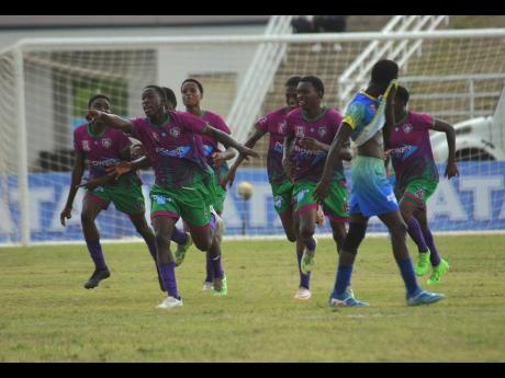 Credit: Ashley Anguin Ashley Anguin/Photographer
William Knibb Memorial High players celebrate a goal during their Zone D ISSA/WATA Manning Cup game against Cedric Titus at the Trelawny Multi-Purpose Stadium yesterday.