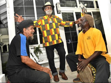 Credit: File Monte Blake, (centre) dancing to the drumming by Calvin Mitchell (left) and Phillip Supersad at the media launch of the 32nd Merritone Family Reunion and Homecoming, in 2022.