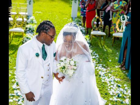 Credit: Miguel Gayle Photography The couple shares a beautiful moment at their garden wedding in Hope Gardens, St Andrew.