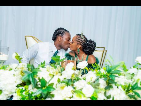 Credit: Miguel Gayle Photography
The newly-weds seal their love with a kiss.