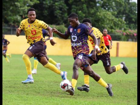 Credit: Antoine Lodge Haile Selassie High School’s Dujay Garrick (left) and Kishawn Valentine (right) go in chase of St Andrew Technical High School’s Dwayne Atkinson during an ISSA Manning Cup encounter at Haile Selassie yesterday.