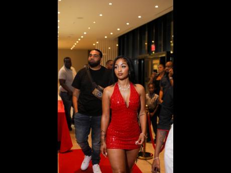 Dancehall artiste Shenseea enters the AC Hotel on Wednesday evening to sign her ambassador deal with Sunshine Snacks, with her manager, Romeich Major, walking behind her.
