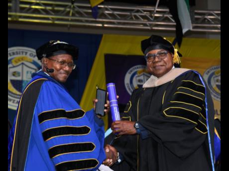 Credit: Contributed Tourism Minister Edmund Bartlett (right) receiving his honorary doctorate in hospitality and tourism management (Honoris Causa) from the University College of the Caribbean, in July 2024.