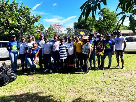 The WPM Waste Management Limited team shares a photo with volunteers from the Farm Primary Environmental Club at the Fisherman’s Beach in St James, during International Coastal Clean-up (ICC) Day on Saturday, September 21.