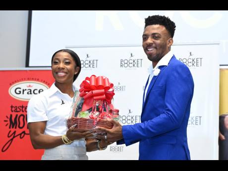 Credit: Rudolph Brown Tahj Lumley, guest speaker of the 2024 Pocket Rocket Foundation’s annual Scholarship Awards presentation accepts a gift from Shelly-Ann Fraser-Pryce after delivering the keynote address.