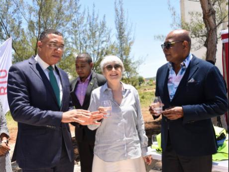 Credit: Ashley Anguin Prime Minister Andrew Holness speaks with Carmen Riu, owner of the RIU Hotels & Resorts chain, and Edmund Bartlett, minister of tourism, at the groundbreaking ceremony of RIU Aquarelle in Coopers Pen, Trelawny, on Wednesday, April 20. In the background is