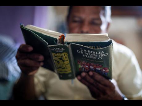 Credit: AP Carlos Herrera Nicaraguan exile Francisco Alvicio, a deacon of Nicaragua’s Moravian Church, reads a Bible in his rented room in San Jose, Costa Rica, Sunday, September 22.