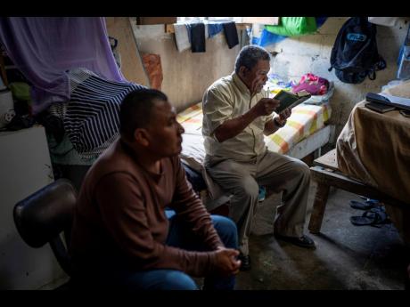 Credit: AP Carlos Herrera Nicaraguan exile Francisco Alvicio (right), a deacon of Nicaragua’s Moravian Church, prays in his rented room alongside fellow exile and Miskito leader, Salomon Martinez Ocampo, in San Jose, Costa Rica, on September 22.