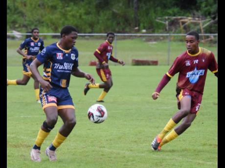 Credit: Ashley Anguin
Munro College’s Akel Vesprey (left) is confronted by Maggotty High’s Trayvon Haughton during their Zone E ISSA/WATA daCosta Cup football match at Munro College on Wednesday.
