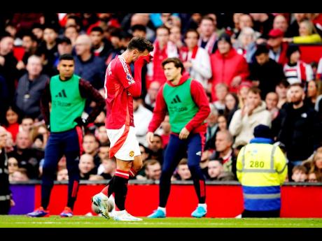 Manchester United’s Bruno Fernandes walks off the pitch after receiving the red card for a foul during the English Premier League  match against Tottenham Hotspur at Old Trafford stadium in Manchester, England, yesterday. Tottenham won 3-0.