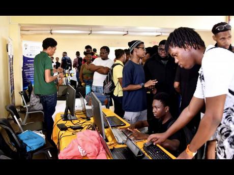 University students eagerly engage with digital programmes at UTech, Ja School of Computing and Information Technology (SCIT) exhibition booth during the 2nd annual Microsoft Day event held on October 5, 2023, at the University of Technology, Jamaica Papin