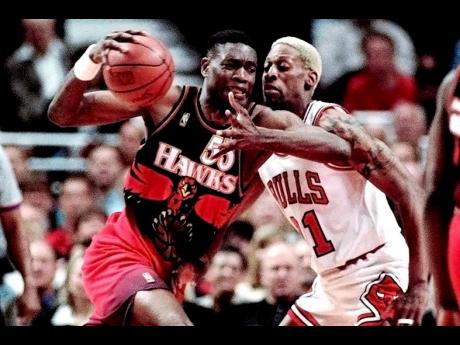The Atlanta Hawks’ Dikembe Mutombo (left) drives to the hoop against the Chicago Bulls’ Dennis Rodman during the second quarter of their playoff game on Thursday, May 8, 1997, in Chicago. 