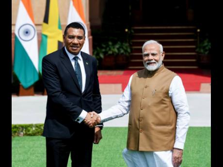 Prime Minister Andrew Holness (left) greets India’s Prime Minister Narendra Modi at Hyderabad House in New Delhi, India, on Tuesday, October 1. 
