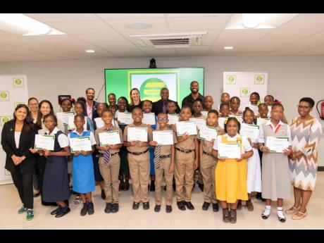 The 2024 cohort of Seprod Foundation PEP scholarship recipients proudly display their scholarship certificates, posing for a photo op with Seprod Group and Seprod Foundation stakeholders during the awards ceremony held on September 18 in Kingston. 