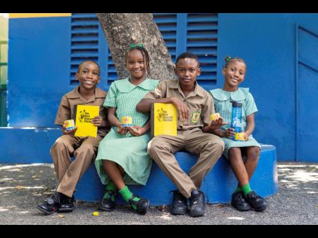 Grade six students of St Peter Claver Primary (from left): Abijah Francis, Janel Rose, Ragek Clark, and Khloe Gordon, proudly showcase their new school supplies, generously donated by The Best Dressed Chicken. This initiative provided 1,000 essential suppl