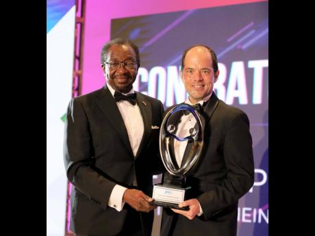 Credit: Contributed US Ambassador to Jamaica N. Nickolas Perry (left) presents the début Inclusivity Champion Award to Red Stripe Managing Director Daaf van Tilburg (right).