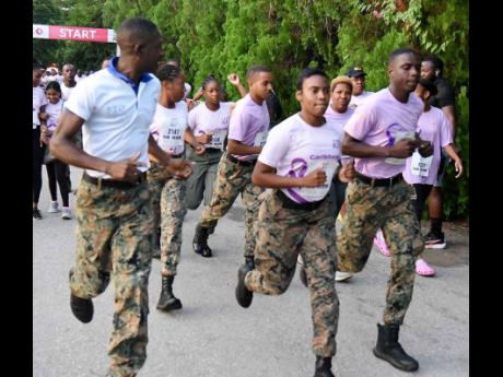 Members of the Jamaica Defence Force (JDF), sporting purple tops, at the start the CIBC Caribbean’s Run/Walk for the Cure (WFTC) Sunday morning inside the Hope Botanical Gardens in St. Andrew.  