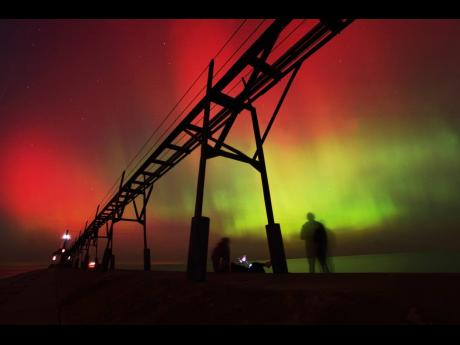 
An aurora borealis, also known as the northern lights, lights up the night sky off Lake Michigan and the St Joseph Lighthouse, Thursday, Oct. 10, 2024, in St Joseph, Michigan, in the United States.