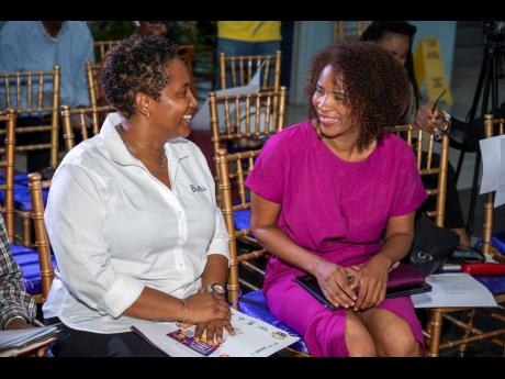Tanketa Chance-Wilson (left), executive director, Barita Investment Limited, having a conversation with Lupus Foundation of Jamaica (LFJ) president Dr Desiree Tulloch-Reid at the launch of the LFJ, Lupus Awareness Month Public Awareness Campaign. 