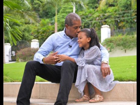 Chairman of the Factories Corporation of Jamaica, Lyttleton ‘Tanny’ Shirley hugs his daughter, Nella.