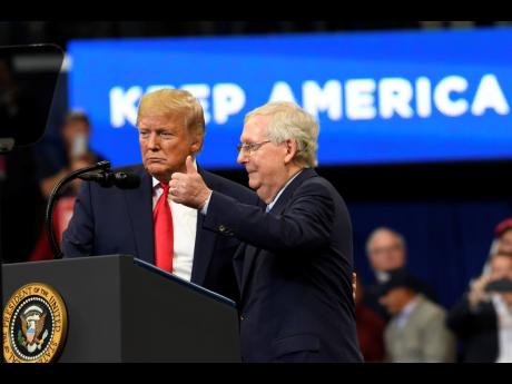 President Donald Trump brings Senate Majority Leader Mitch McConnell on stage during a campaign rally in Lexington, Kentucky in November 2019. 