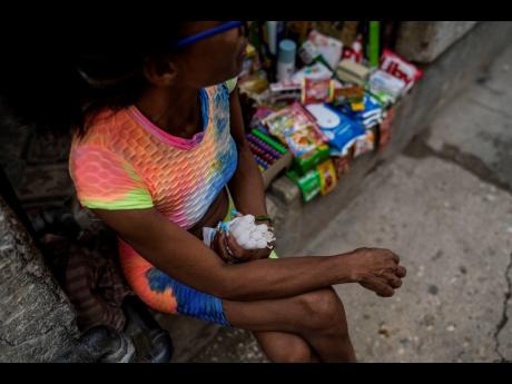A street vendor selling candles waits for customers during a blackout following the failure of a major power plant in Havana, Cuba on October 19.