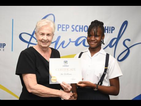 Jennifer Martin (left), JN Foundation board director, presenting Xia Williams with a certificate at the awards ceremony to recognise JN PEP Scholars at The Jamaica Pegasus hotel, recently.