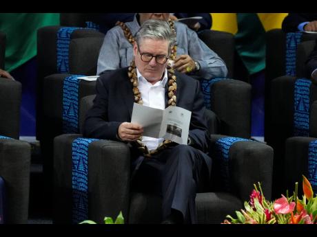 Credit: AP British Prime Minister Keir Starmer reads a programme during the opening ceremony of the Commonwealth Heads of Government meeting in Apia, Samoa, Friday, October 25.