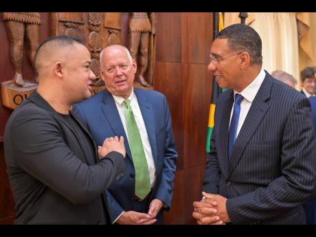 Prime Minister Andrew Holness (right), in discussion with Paris Lyew-Ayee Jr (left) while Jack Craig, chief executive officer of Canadian Nuclear Laboratories Limited, looks on.