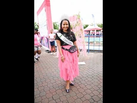 Although not running this year, Kaydian McKoy, a breast cancer survivor and the reigning Miss Cosmos Queen of Jamaica, pauses her duties to pose for a quick photo op.
