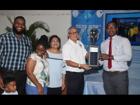 The family of St Georges College (STGC) past student Hubie Chin (second right), last week celebrated his 75th birthday by making a contribution of $1 million to the school’s football programme and to the Hubie Chin Annual Trophy for the Under-15 Most Val