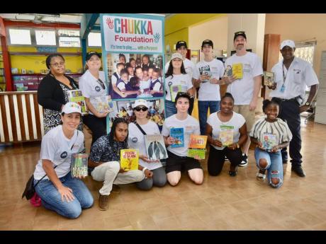 Credit: Contributed Members of the Books Overseas, an international charity organisation, with representatives of the Chukka Foundation in front of the St James Library in Montego Bay, celebrating a recent donation of books to the facility. Books Overseas recently donated 1,2